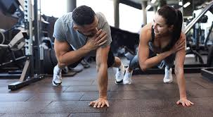 Image of man and woman doing Cardio Ashtead to tone their arms. 